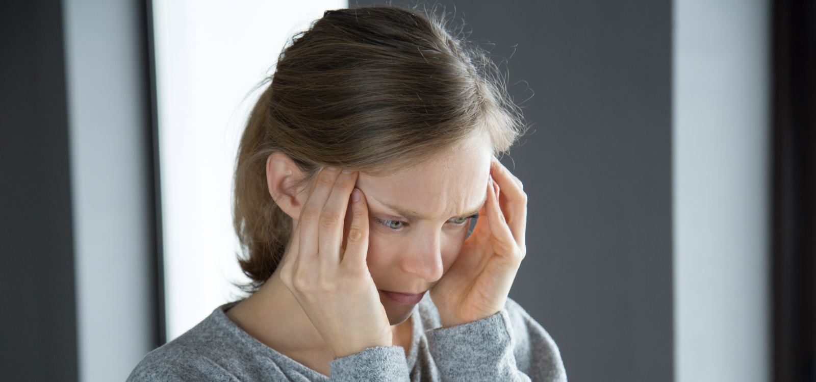 Woman experiencing migraine